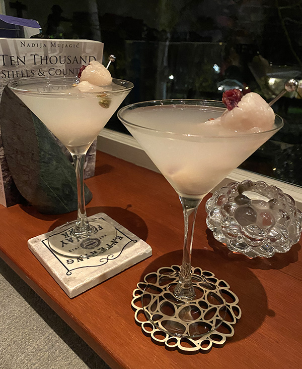 Two Lychee Martinis by the window are a bright contrast to a dark evening.