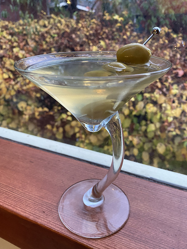 A Dirty Martini is garnished with three olives.