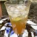 A gin and tonic made with homemade tonic has an amber color.