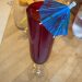 This non-alcoholic Mimosa goes in a beautiful red glass, with an umbrella.
