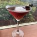 A dirty martini sits on a windowsill.